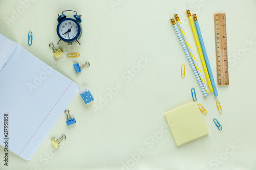 set of school stationery: pencils, clock, workbooks, notepad, paper clips . Education, back to school, lesson concept