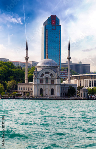 Dolmabahce Mosque and modern skyscraper, Istanbul, Turkey photo