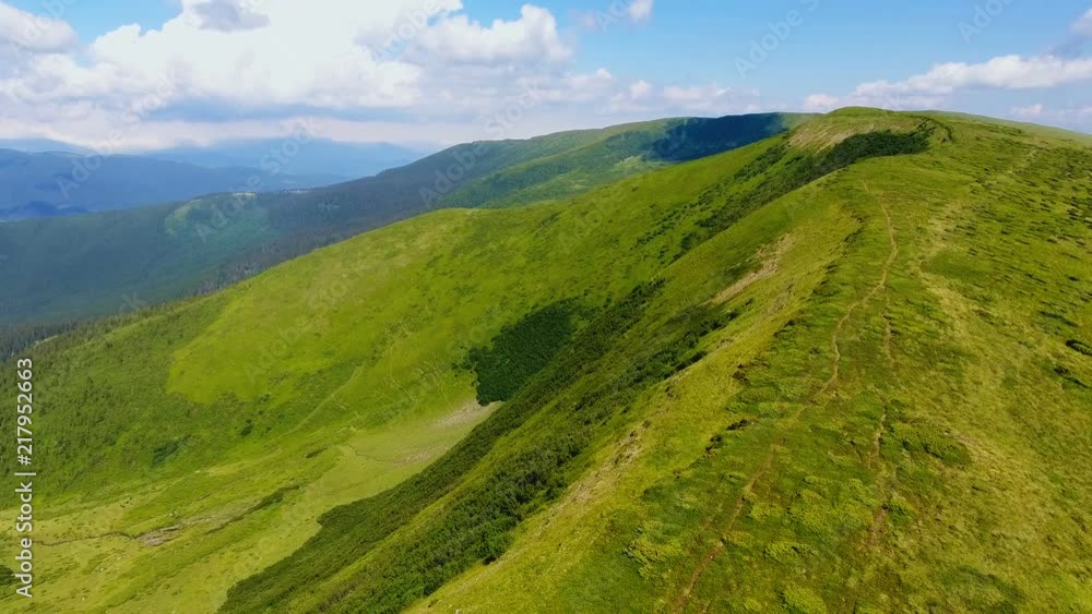 Aerial shot of a horseshoe mountain with a lane over it n the Carpathians in summer Aerial shot of a horseshoe mountain with a lane over it n the Carpathians in summer