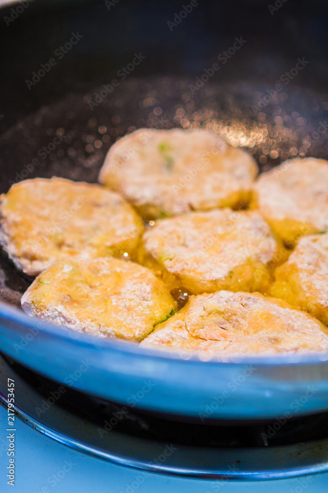 Crab and Fish Cakes Cooking in a Blue Pan Crab and Fish Cakes Cooking in a Blue Pan