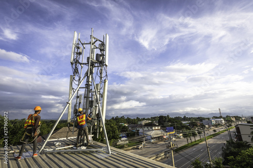 technician installing communication tool on high pole
