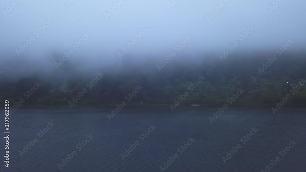 Aerial view of clouds and fog over Bratan lake in Bali, Indonesia drone footage Aerial view of clouds and fog over Bratan lake in Bali, Indonesia drone footage