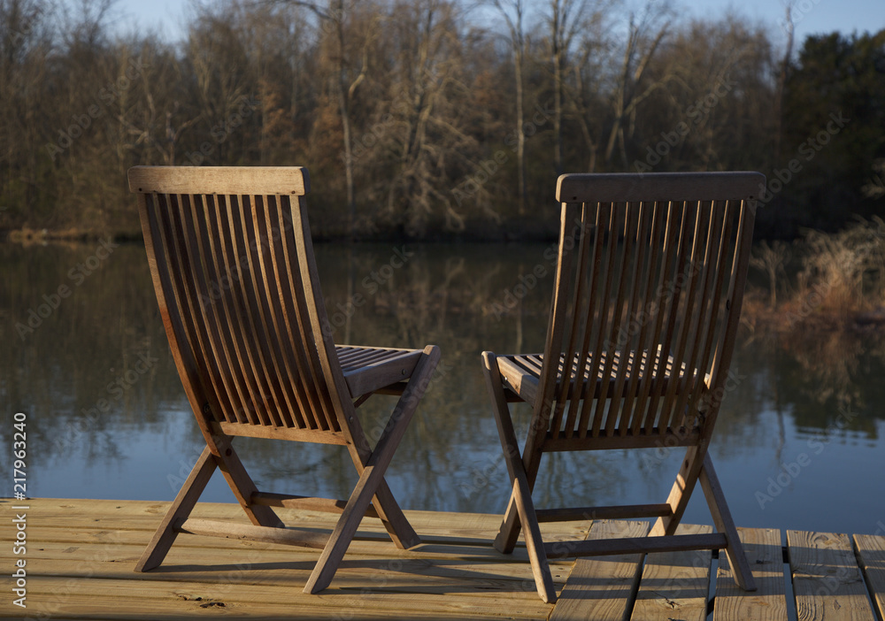 Two Teak Chairs on a Lake Dock