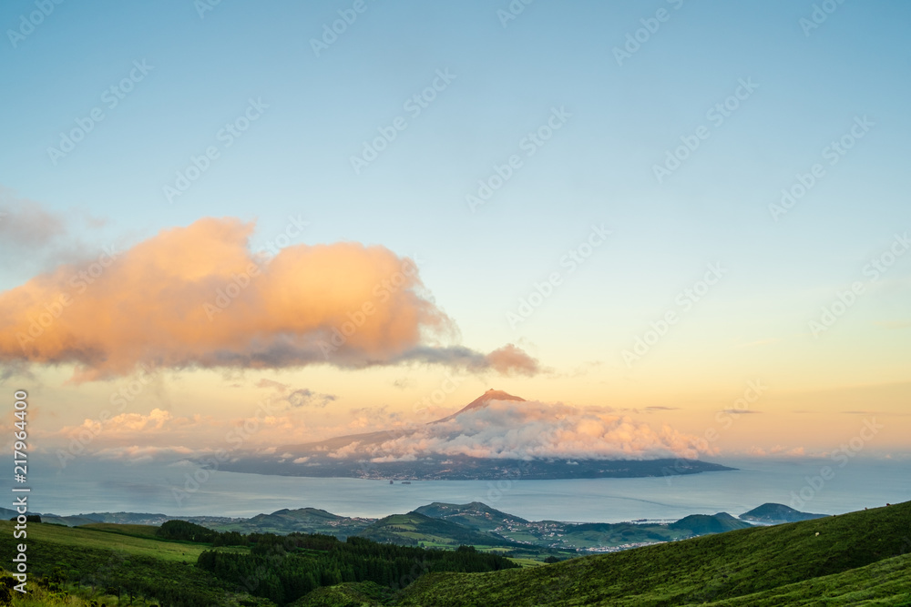 A view to Pico Island from Faial during a sunset with some clouds