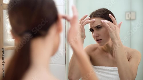 Problem Skin. Woman Crushing Spot On Face And Looking In Mirror