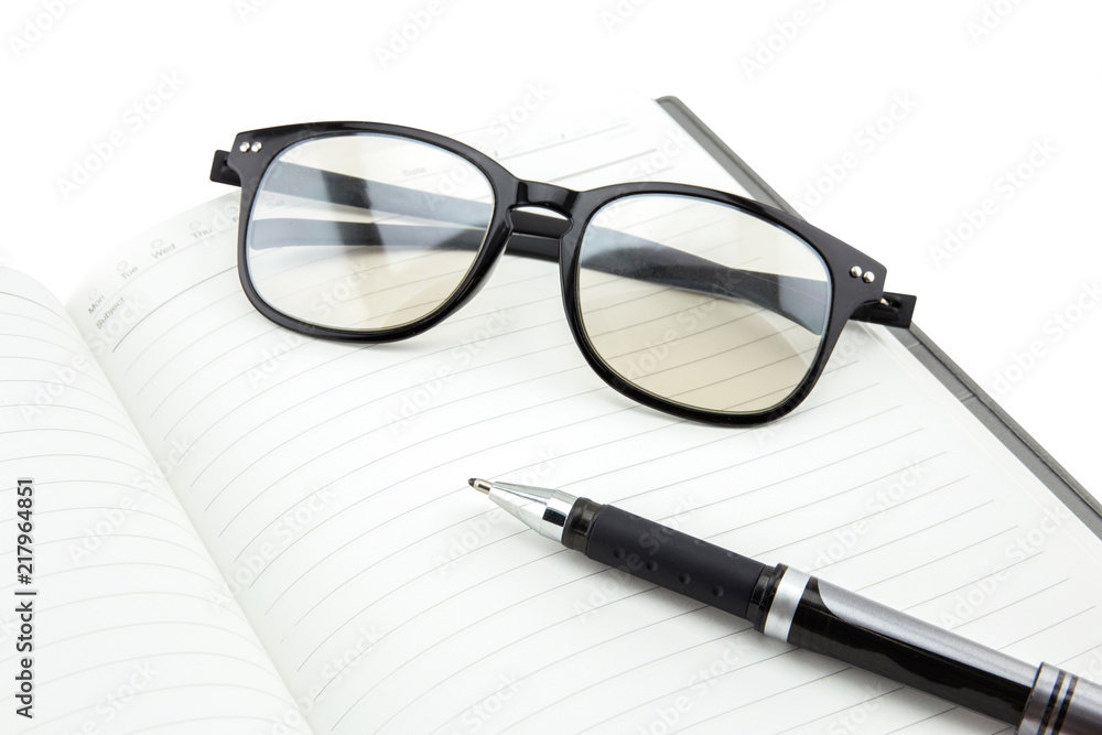 A black pen and empty open book on white background A black pen and empty open book on white background