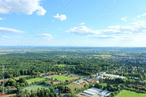 Amazing Landscape view on the beautiful forests, alpine mountains and idyllic fields of South Germany with a blue sky before sunset with clouds