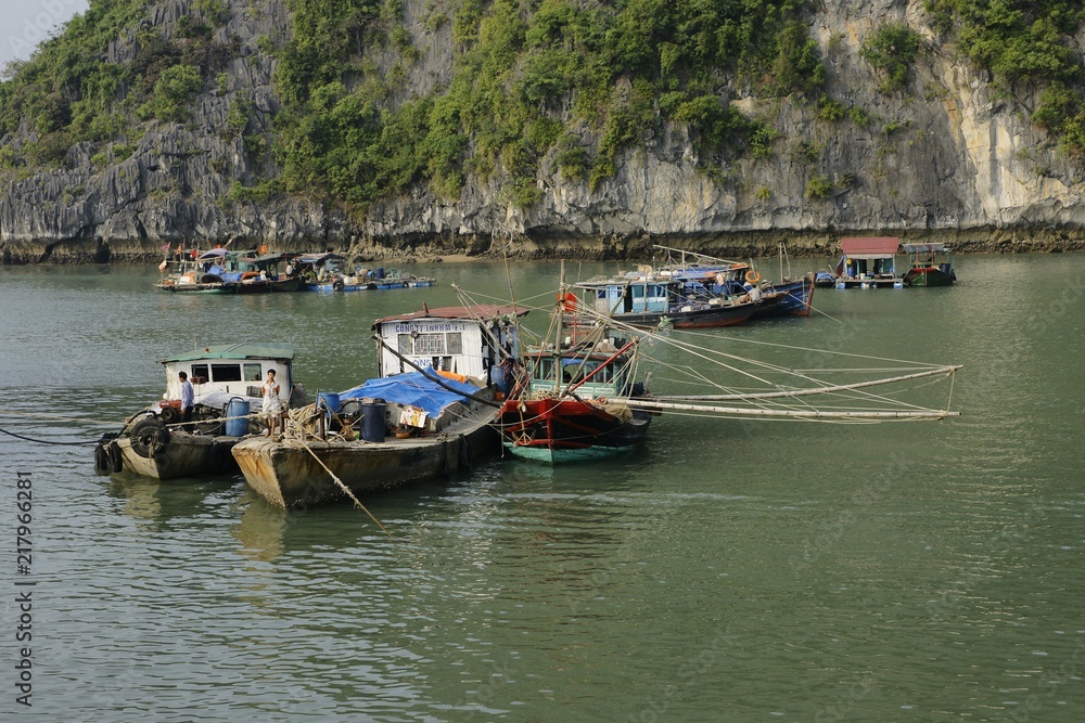 Halong bay, Vietnam - May 11, 2013: Typical wooden boats for tourists sailing through the Cat Ba area, in Ha Long Bay.