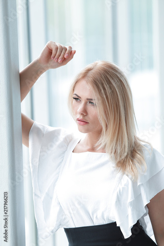 modern business woman sitting near the window in the office. Free Download modern business woman sitting near the window in the office. - GFXLoad