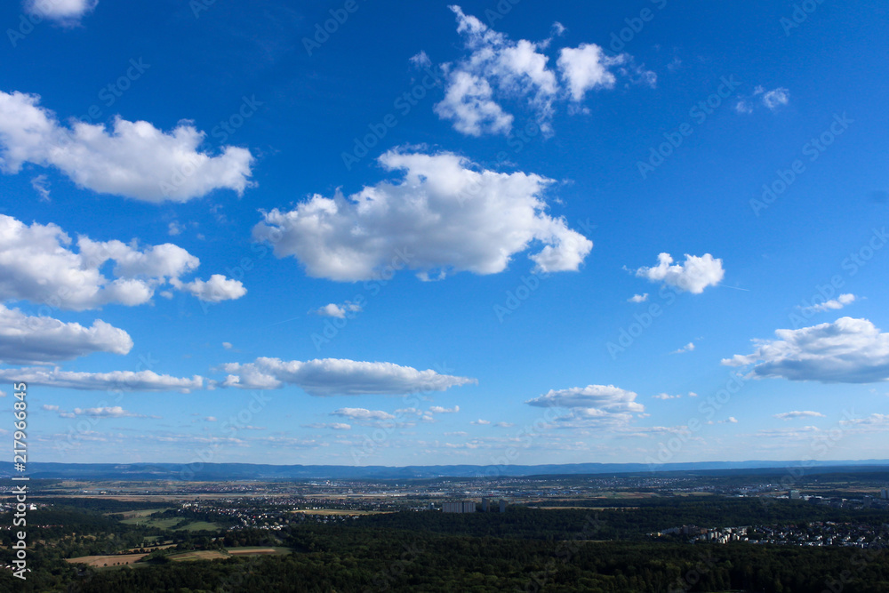 Amazing Landscape view on the beautiful forests, alpine mountains and idyllic fields of South Germany with a blue sky before sunset with clouds Amazing Landscape view on the beautiful forests, alpine mountains and idyllic fields of South Germany with a blue sky before sunset with clouds