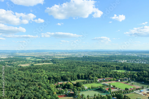 Amazing Landscape view on the beautiful forests, alpine mountains and idyllic fields of South Germany with a blue sky before sunset with clouds