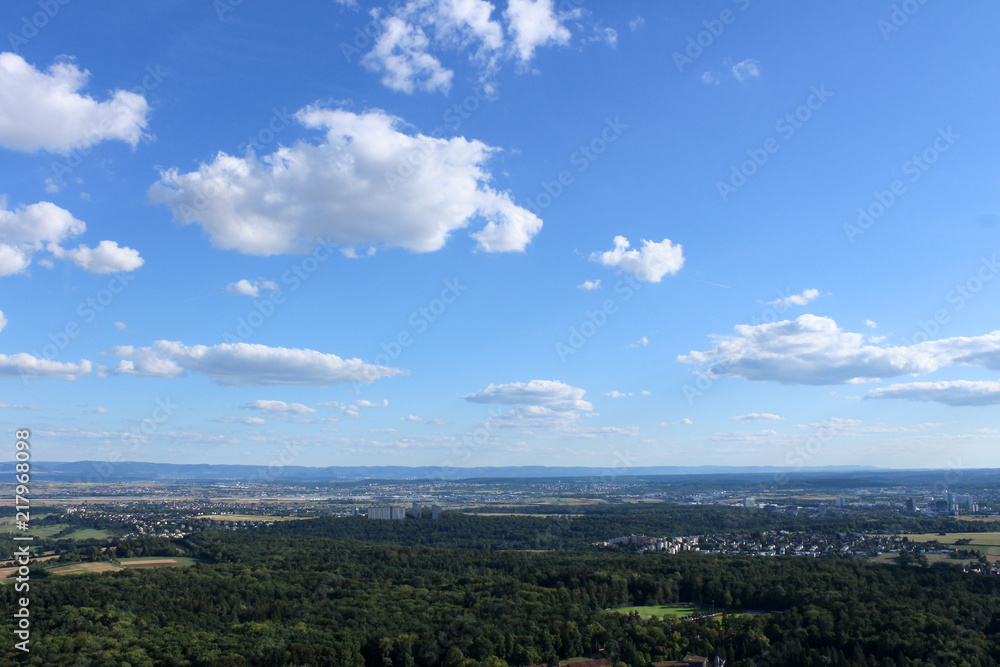 Amazing Landscape view on the beautiful forests, alpine mountains and idyllic fields of South Germany with a blue sky before sunset with clouds Amazing Landscape view on the beautiful forests, alpine mountains and idyllic fields of South Germany with a blue sky before sunset with clouds