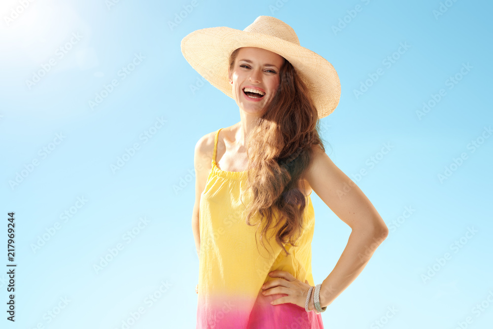 happy young woman in colourful dress against blue sky happy young woman in colourful dress against blue sky