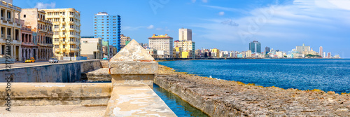 The famous seaside Malecon wall and the skyline of Havana © kmiragaya