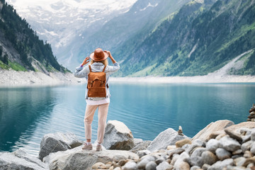 Traveler look at the mountain lake. Travel and active life concept. Adventure and travel in the mountains region in the Austria