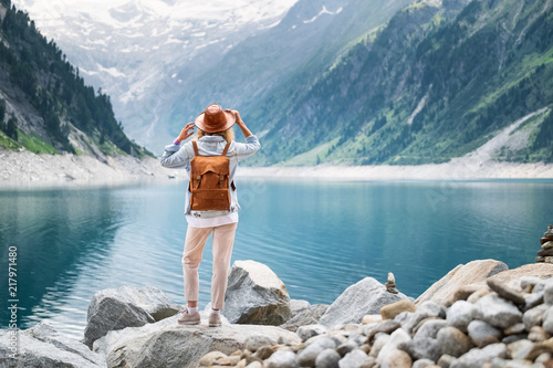 Traveler look at the mountain lake. Travel and active life concept. Adventure and travel in the mountains region in the Austria