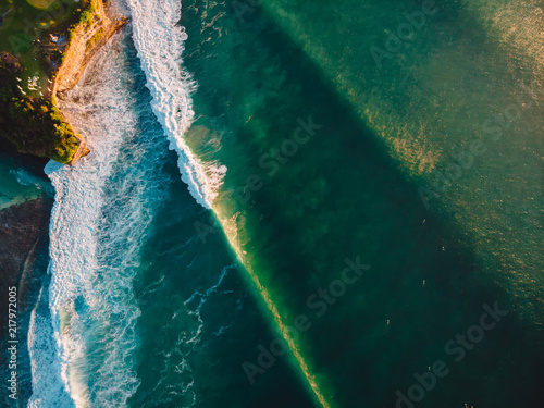 Aerial view of stormy waves at sunset. Biggest ocean wave with green tones