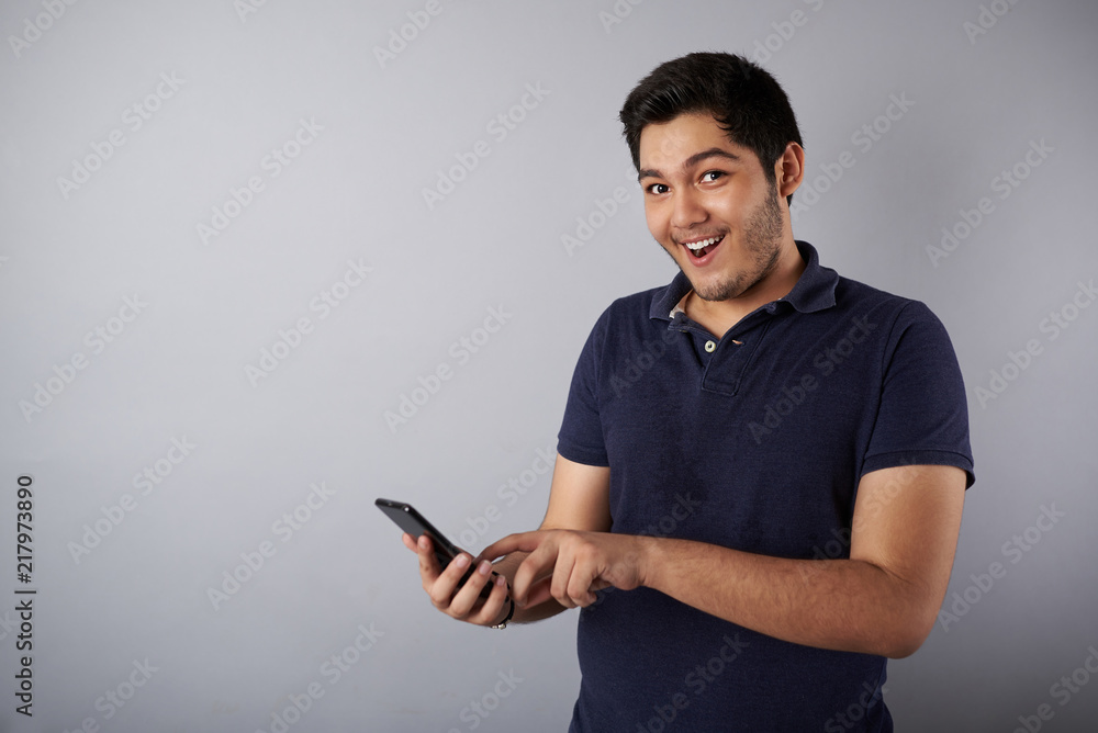 Funny young man using smartphone Funny young man using smartphone
