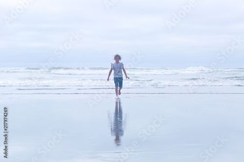 Small, Cute, 6 years Girl, Brown hair, playing in the water, running, Pacific Ocean, Oregon coast, family vacation time, reflection in the water