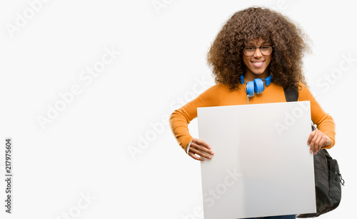 African american student woman holding blank advertising banner, good poster for ad, offer or announcement, big paper billboard photo