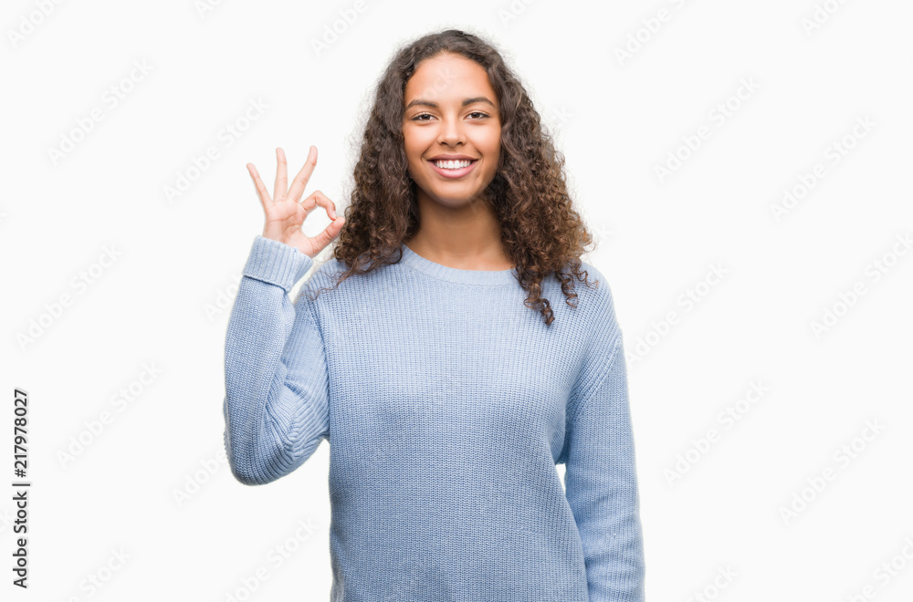 Beautiful young hispanic woman doing ok sign with fingers, excellent symbol Beautiful young hispanic woman doing ok sign with fingers, excellent symbol