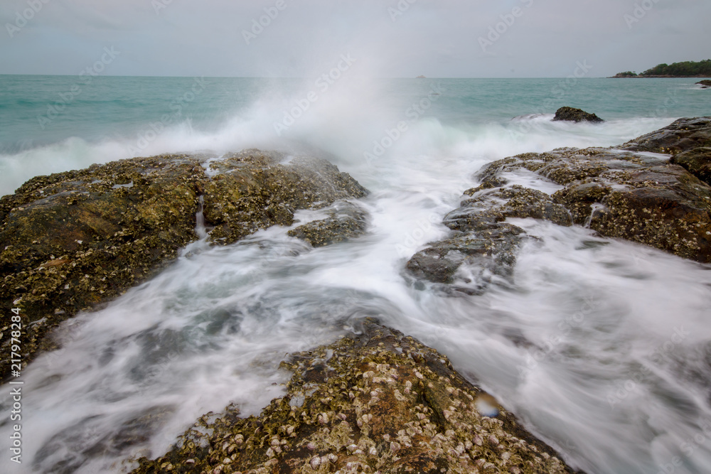 Sea waves crashing to rocks creating foam Sea waves crashing to rocks creating foam