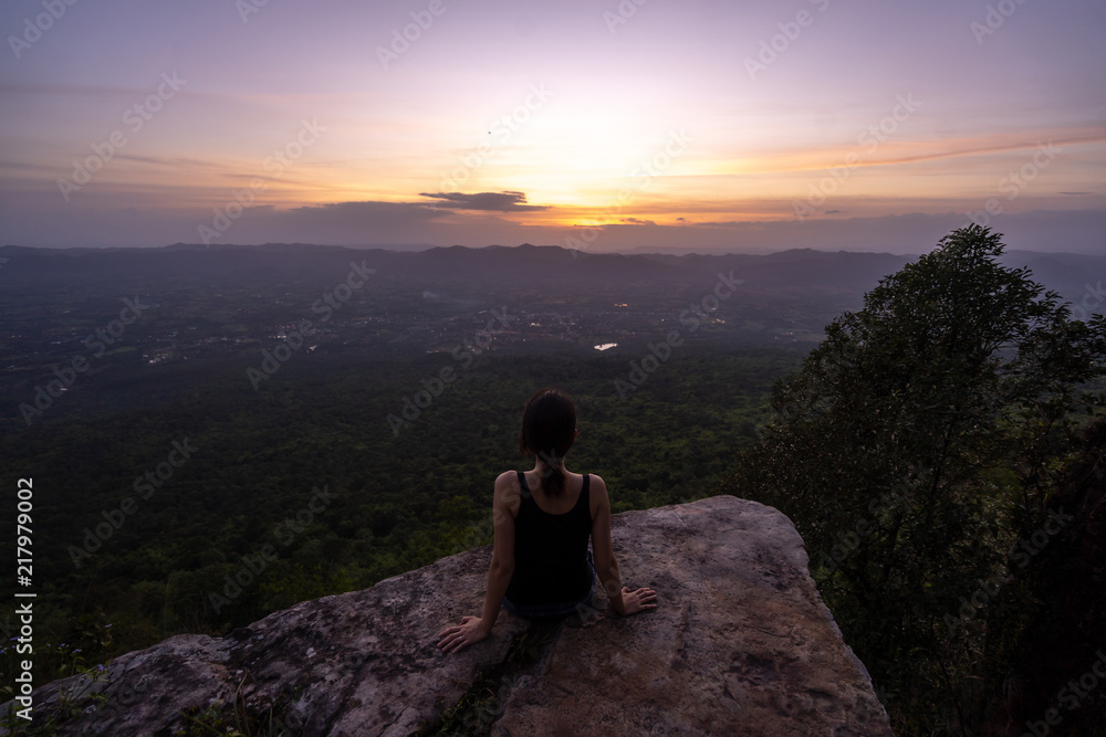 silhouette woman sitting on mountain