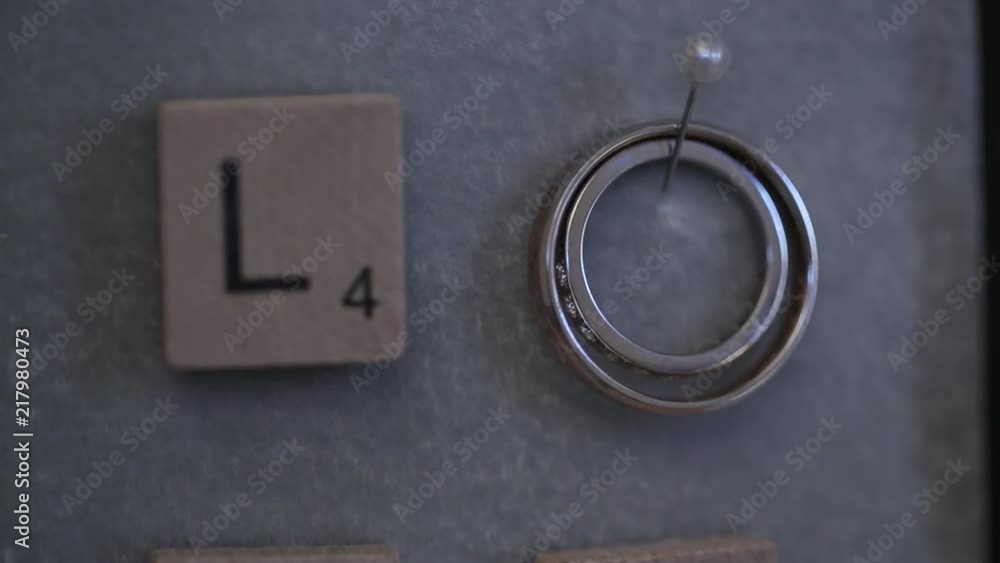 Silver Wedding Rings on the wall with love macro closeup shoot diamon Jewellery Silver Wedding Rings on the wall with love macro closeup shoot diamon Jewellery