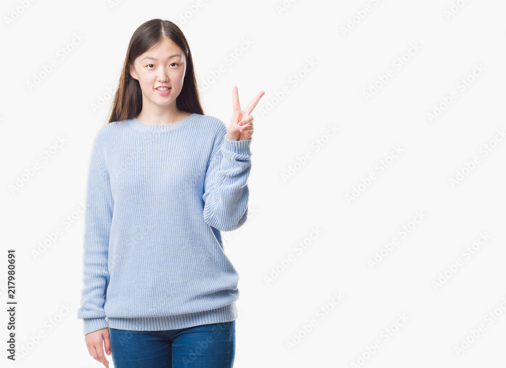 Young Chinese woman over isolated background showing and pointing up with fingers number two while smiling confident and happy. Young Chinese woman over isolated background showing and pointing up with fingers number two while smiling confident and happy.