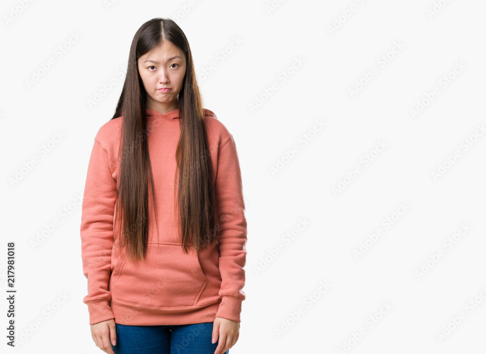 Young Chinese woman over isolated background wearing sport sweathshirt depressed and worry for distress, crying angry and afraid. Sad expression. Young Chinese woman over isolated background wearing sport sweathshirt depressed and worry for distress, crying angry and afraid. Sad expression.