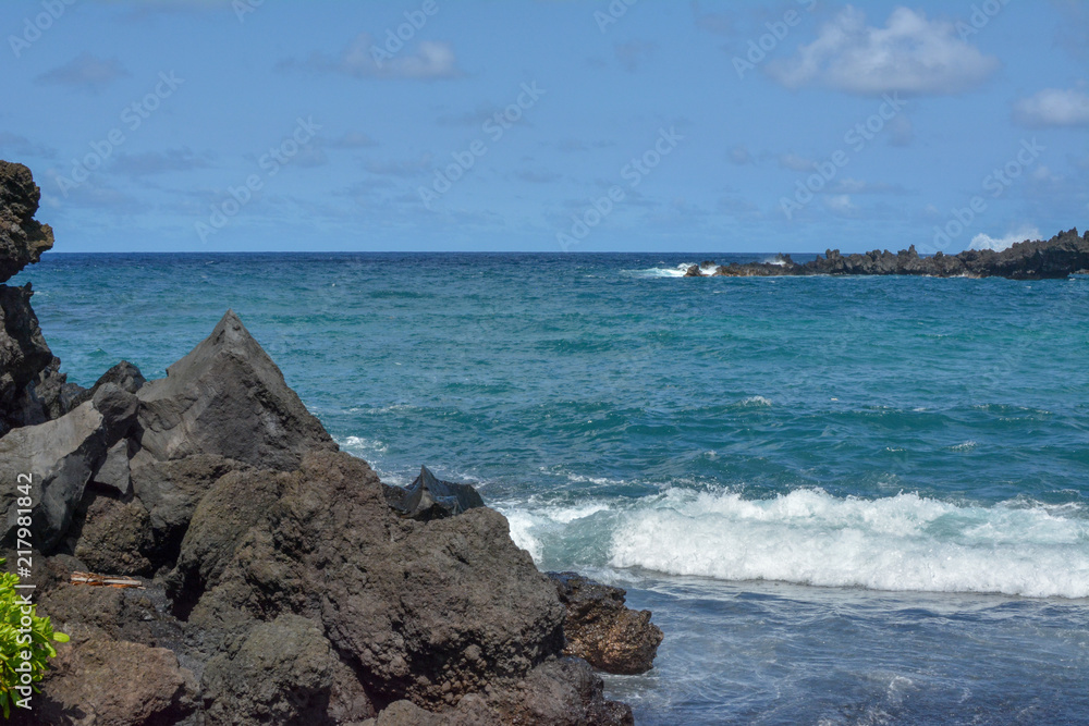 Black sand beach with lava rock on the island of Maui, Hawaii