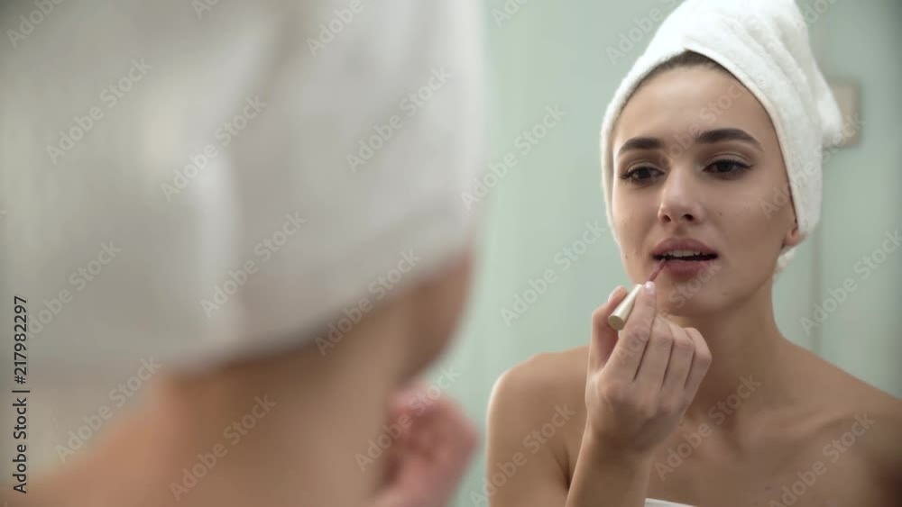 Lips Makeup. Woman Using Liquid Lipstick At Bathroom Lips Makeup. Woman Using Liquid Lipstick At Bathroom