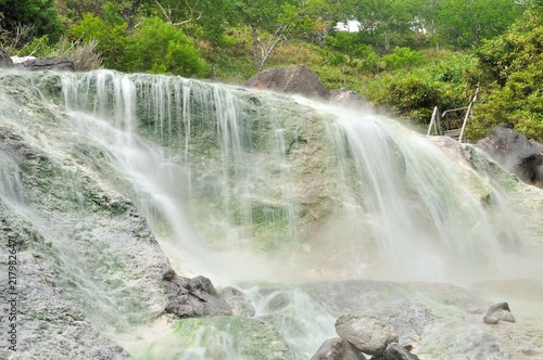 steam waterfall on river thermal spring of baransky volcano iturup island photo