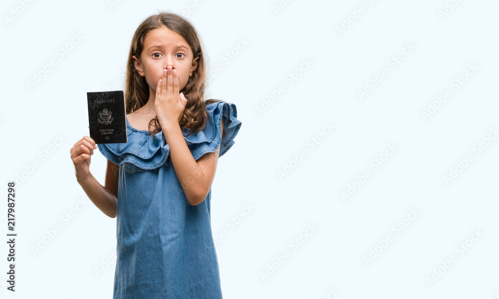 Brunette hispanic girl holding passport of United States of America cover mouth with hand shocked with shame for mistake, expression of fear, scared in silence, secret concept Brunette hispanic girl holding passport of United States of America cover mouth with hand shocked with shame for mistake, expression of fear, scared in silence, secret concept
