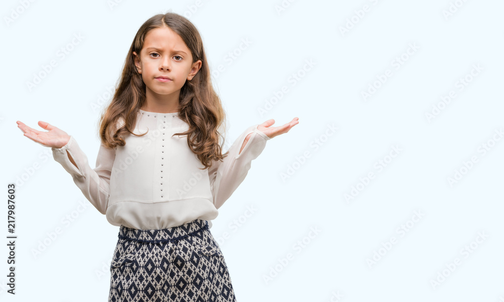 Brunette hispanic girl clueless and confused expression with arms and hands raised. Doubt concept. Brunette hispanic girl clueless and confused expression with arms and hands raised. Doubt concept.