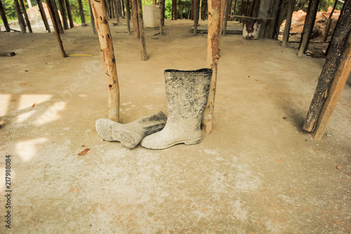 Dirty rubber boots at the construction sute photo