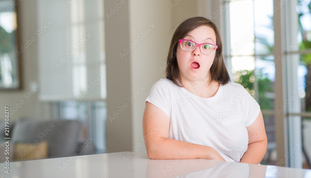 Down syndrome woman at home scared in shock with a surprise face, afraid and excited with fear expression Down syndrome woman at home scared in shock with a surprise face, afraid and excited with fear expression