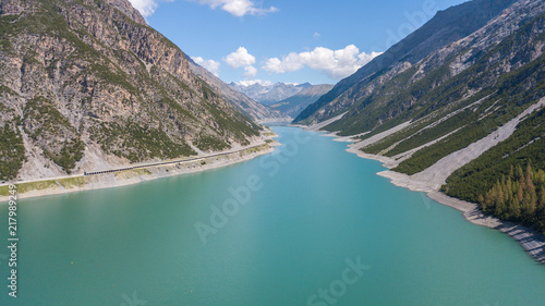 Drone aerial view of the Lake Livigno an alpine artificial lake. Italian Alps. Italy