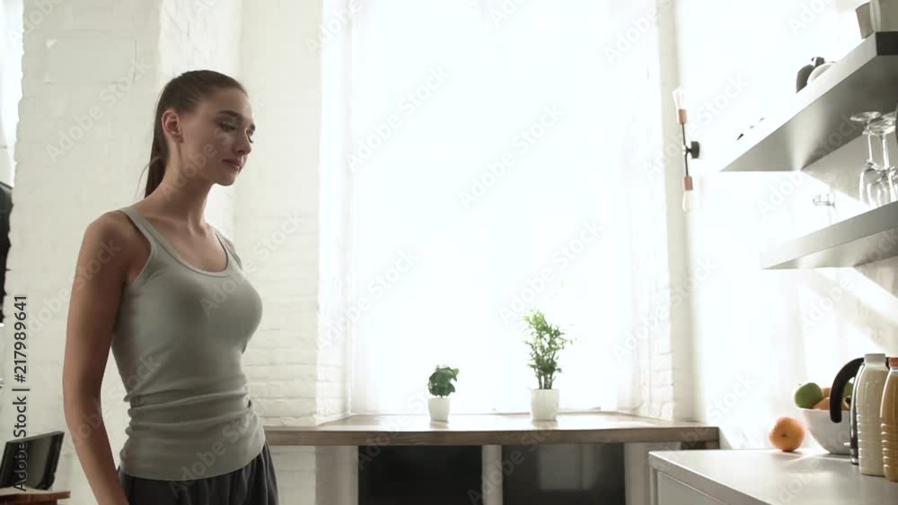 Woman In Kitchen Taking Wooden Board And Bread In Morning Woman In Kitchen Taking Wooden Board And Bread In Morning