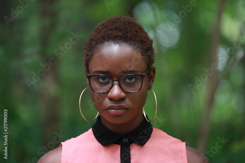 Emotionless ethnic young woman in accessories photo