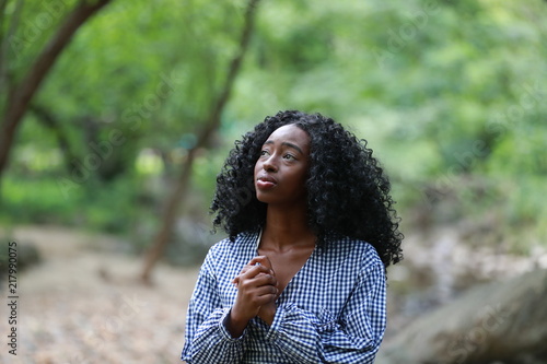 Charming black woman looking up with hope