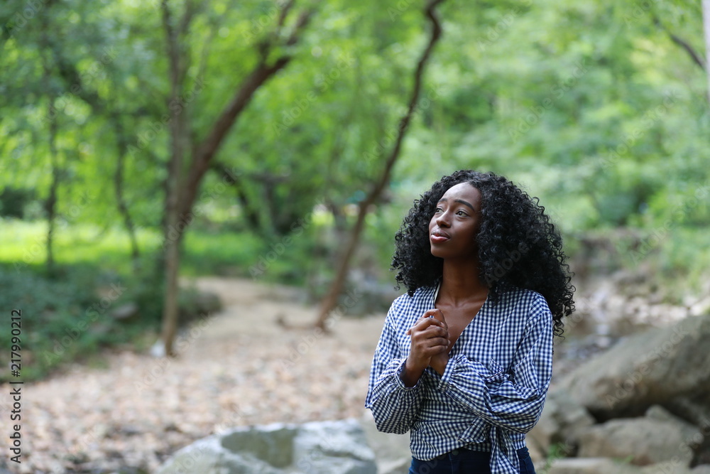 Innocent beautiful black woman praying alone Innocent beautiful black woman praying alone
