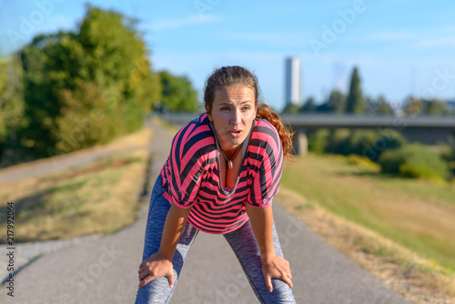 Smiling woman resting after running © michaelheim