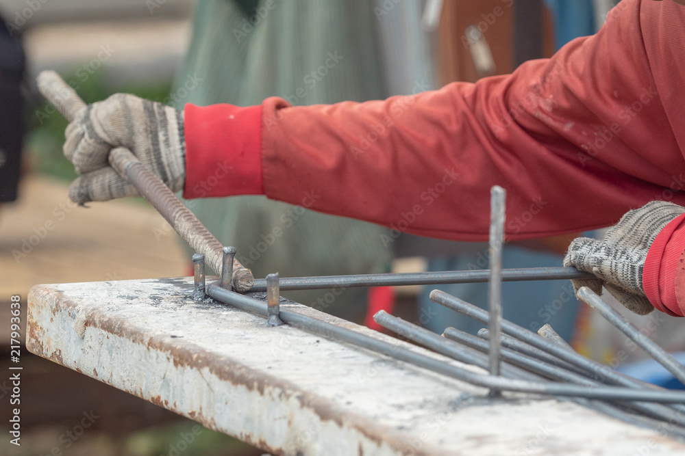 close up hand construction worker use glove bundle steel bar in construction site close up hand construction worker use glove bundle steel bar in construction site