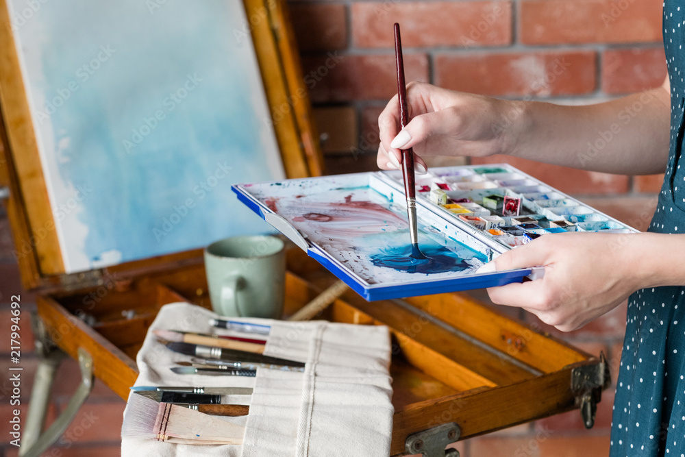Obraz premium art painting hobby. creative leisure. artist mixing watercolors preparing to draw picture. talent inspiration creation and self expression concept.