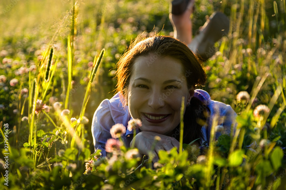 Nice woman outdoors in a summer sunny evening Nice woman outdoors in a summer sunny evening