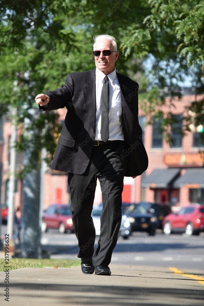Pointing Adult Male Politician Walking On Sidewalk Pointing Adult Male Politician Walking On Sidewalk