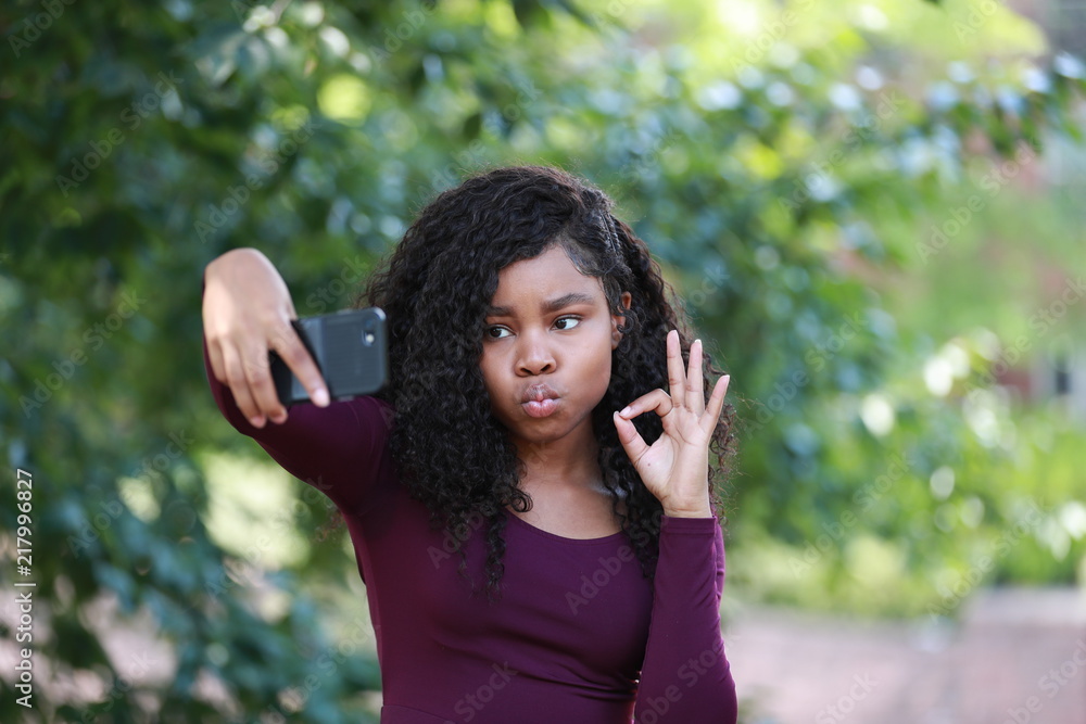 Black woman puffing lips and gesturing OK for selfie Black woman puffing lips and gesturing OK for selfie