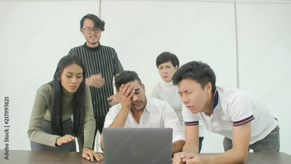 Casual creative business team getting very bad news on his laptop computer screen and feeling disappoint. Casual creative business team getting very bad news on his laptop computer screen and feeling disappoint.
