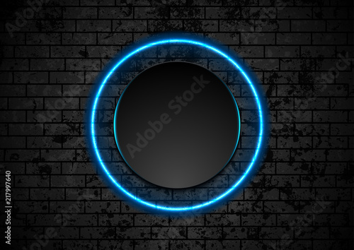 Blue neon circle on grunge brick wall background